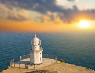 Fototapeta na wymiar lighthouse on a marine cape at the sunset