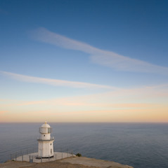 Fototapeta na wymiar lighthouse on a marine cape at the twilight