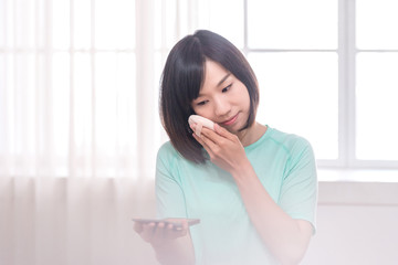asian women make up her face in room