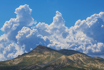 mount top under a huge cumulus clouds