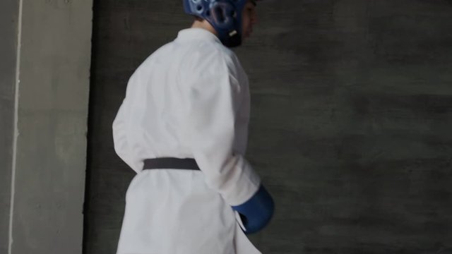 Sparring or single duels in taekwondo class. Pupils kicking in a fighting stance. Forceful attack and defense tactics. Traditional martial arts school. Middle shoot.