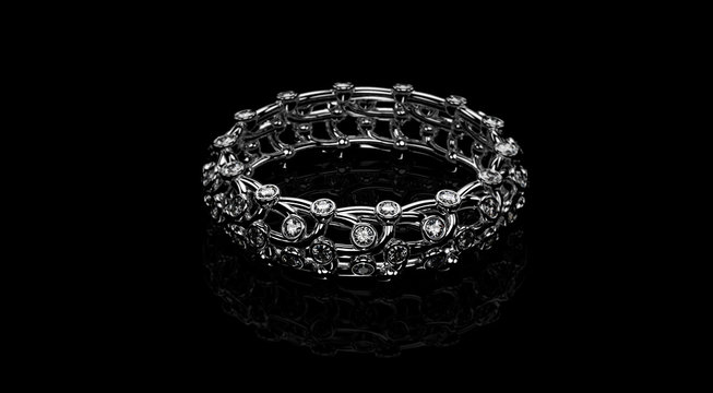 Lying openwork platinum Band Ring with diamonds isolated on a white background. 3D rendering