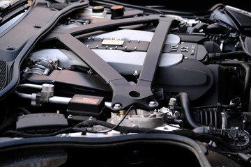 Modern Luxury Car V12 Engine Under Hood Closeup.