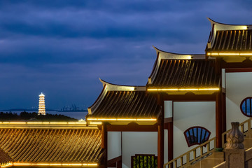 Naklejka premium Towers with lights on at night and buildings in temples