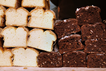 TwoTypes of Fresh Baked White and Black Bread with Corns on a Food Market.