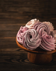 homemade marshmallows on a stand on a wooden background, copy space
