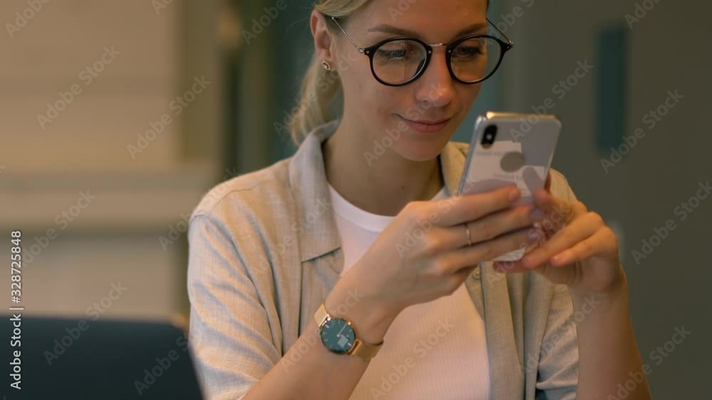 Poster zoom out of cheerful female smartphone user searching web information during network browsing via ce