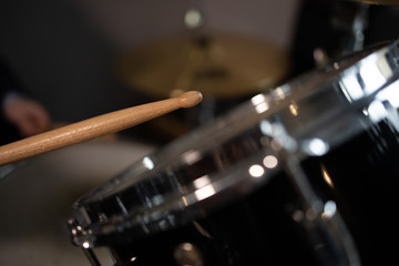 drummer in action, the baton hits the drum drum closeup macro