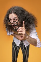 Fotobehang Portrait of a funny nerd making a pointing gesture © konradbak