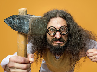 Closeup portrait of a geek holding a hammer