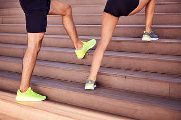 Modern couple doing exercise in urban area.