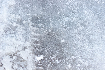 Ice on the road , the texture of a slippery road. Background, macro photography .
