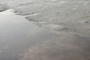 melting ice near the shore of the reservoir