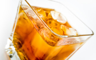 Whisky closeup. Glass of scotish whiskey. Whisky with ice in special glass.