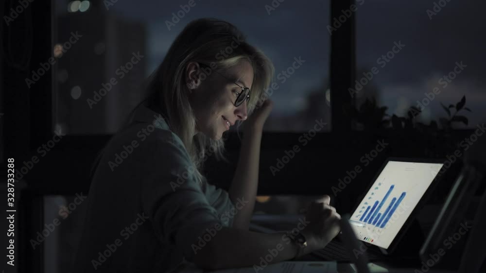 Aufkleber female freelancer working during night time using modern stylus for drawing web graphic diagrams, ca