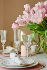 Decor and spring table setting is a vase with pink tulips
