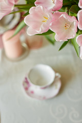 Fototapeta na wymiar Decor and spring table setting is a vase with pink tulips