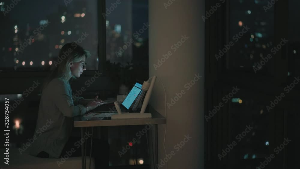 Poster female freelancer doing overtime distance work on modern laptop computer with home internet connecti