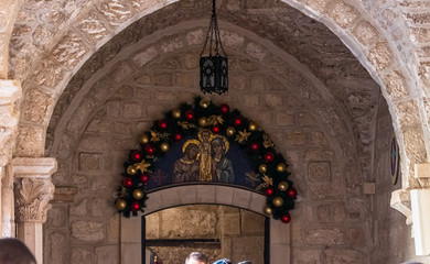 Icon decorated for the celebration of Christmas over the side entrance on the territory of the...