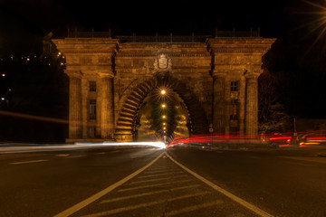 long exposure tunnel in budapest at night.  light drawers drive into a feudal tunnel. the bridge at...