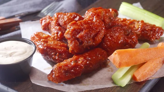 Delicious breaded buffalo chicken wings with  ranch dip, celery and carrot.