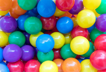 Many colorful plastic balls in a playground.