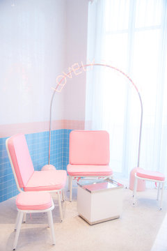 Retro, upholstered, wooden chair by a pink corner room and white table in living room , White and blue wall