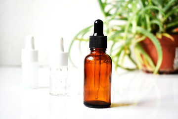 Various  glass bottles for cosmetics, natural medicine , essential oils or other liquids on a white background, top view. Organic