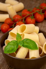 Composition of raw Paccheri Pasta. Variety of traditional Italian pasta in the shape of a tube.