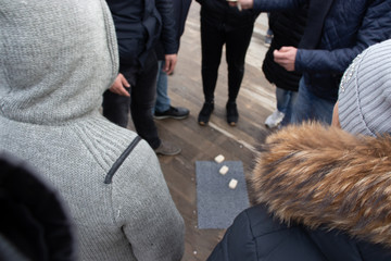 Helsinki, Finland - 3 March 2020: Cheating people on the street. The crowd is standing around and...