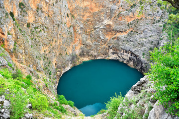 Red Lake (Crveno Jezero) in the crater of an extinct volcano, Croatia. © gadzius
