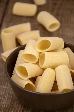 Traditional Italian Pasta Paccheri arranged on wooden table