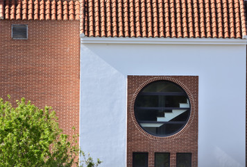 White facade with large round window