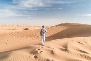 Dubai dessert sand dunes, couple on Dubai desert safari,United Arab Emirates, men on vacation in...