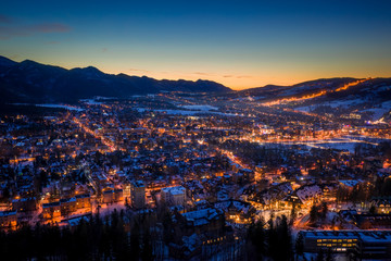Amazing illuminated Zakopane city in winter at night, aerial view - obrazy, fototapety, plakaty