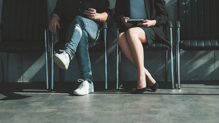 Job application. Professional career. Man woman sitting in chairs waiting for interview.