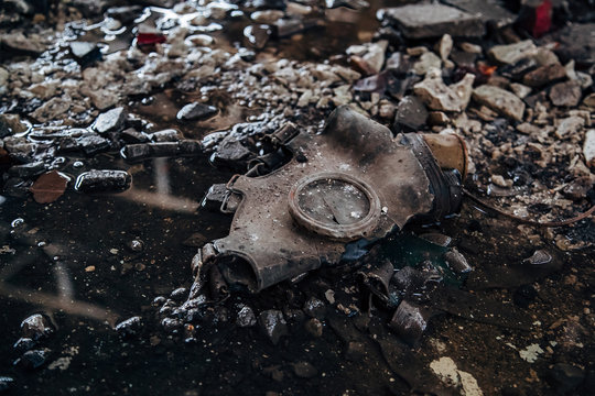 Old rotten Soviet gas mask on dirty floor of abandoned factory