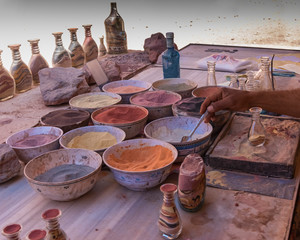 Making souvenirs from colored sand in Petra, Jordan. Life of the local population. Travel, genre...