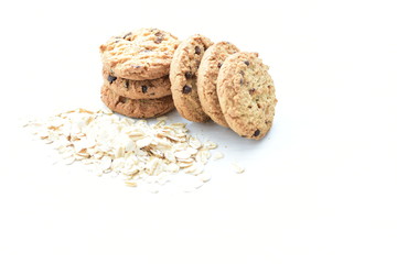 Oatmeal cookies and chocolate chips on light background