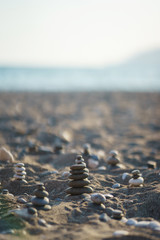 Fototapeta na wymiar Balanced stone pyramid on pabbles beach with sunset. Zen rock, concept of balance and harmony.