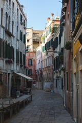 Fototapeta na wymiar Beautiful historic brick buildings on the narrow streets of the ancient city Venice.
