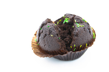 Chocolate cupcake with colored decorative sugar sprinkles isolated on white background