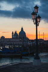 Fototapeta na wymiar View of the Grand Canal and Basilica di Santa Maria della Salute in Venice during sunset.