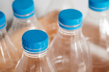 Plastic bottles with blue caps for recycling in a wooden box. Concept of Recycling plastic and ecology. Plastic waste. Stop nature garbage, ecology environment protection concept.