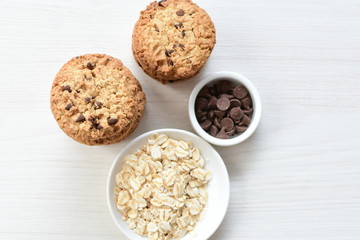 Oatmeal cookies and chocolate chips on light background