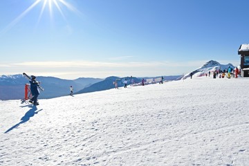  vacationers on a plateau of a ski resort during sunset