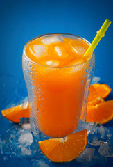 Fresh orange juice against blue background