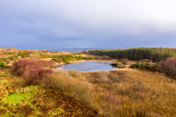 Aerial of lake in a peatbog by Clooney, Portnoo - County Donegal, Ireland