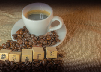 Colombian coffee cup on beans and dark background