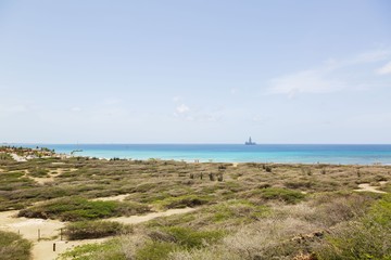 Natural beauty of Aruba. North coast. Off-road Aruba. Amazing stone desert landscape, blue sea and blue sky. 